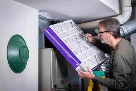 man checking furnace filter